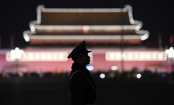 A paramilitary police officer stands guard in Tiananmen Square after a plenary session of the National People's Congress in the adjacent Great Hall of the People in Beijing, China, on March 11, 2018. (Greg Baker/AFP via Getty Images)