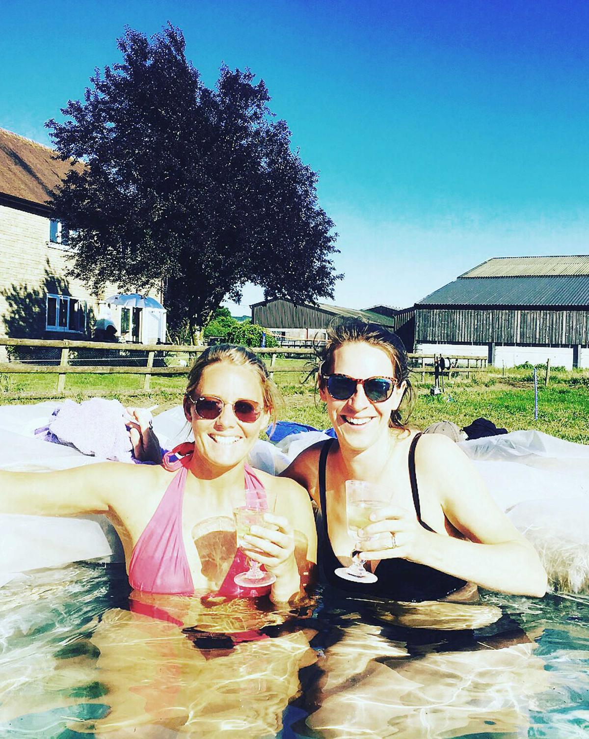 Ed's wife, Jessica (right), and friend Harriet having a drink in the hay bale pool (Caters News)