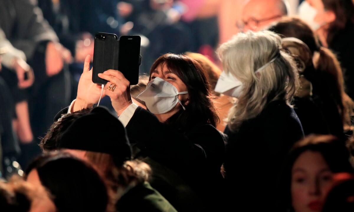 Spectators wear protective masks during the Isabel Marant fashion collection during Women's fashion week Fall/Winter 2020/21 presented in Paris, France, on Feb. 27, 2020. (Michel Euler/AP Photo)