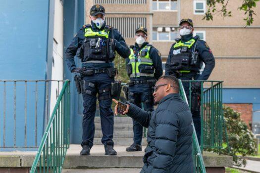 A man is seen seeking to deliver groceries to a family who live at the Flemington Public housing flats and speaks to police in an effort to get access in Melbourne, Australia, on July 5, 2020. (Asanka Ratnayake/Getty Images)