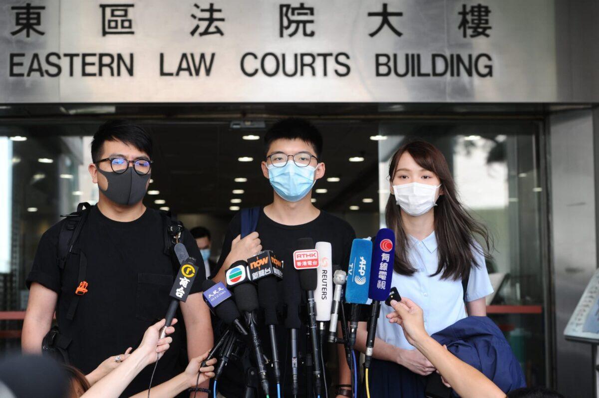 (L-R) Ivan Lam, Joshua Wong, and Agnes Chow speak to reporters after appearing in court in Hong Kong, on July 6, 2020. (Song Bilung/The Epoch Times)