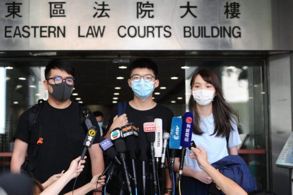  (L-R) Ivan Lam, Joshua Wong, and Agnes Chow speak to reporters after appearing in court in Hong Kong on July 6, 2020. (Song Bilung/The Epoch Times)