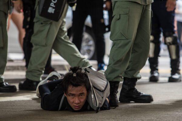 Riot police detain a man as they clear protesters taking part in a rally against a new national security law in Hong Kong on July 1, 2020. (Dale de la Rey/AFP via Getty Images)