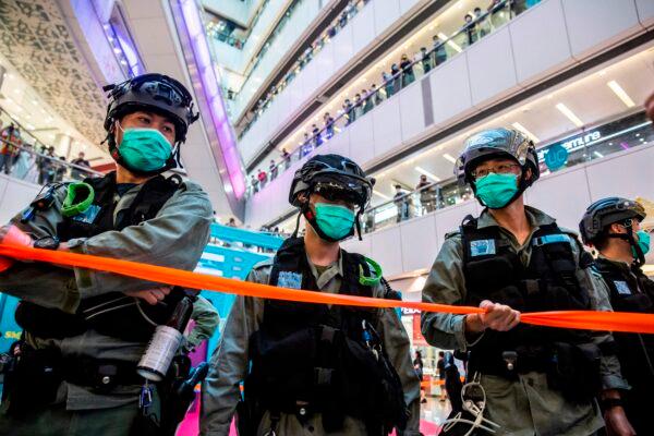 Riot police stand guard during a clearance operation during a demonstration in a mall in Hong Kong on July 6, 2020. (Isaac Lawrence/AFP via Getty Images)