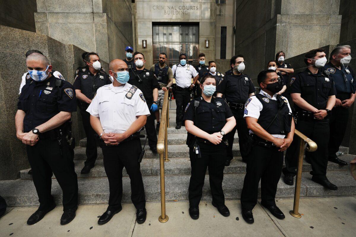 Police watch as protesters gather in front of a Manhattan court house and jail to protest the recent death of George Floyd, in New York City on May 29, 2020. (Spencer Platt/Getty Images)