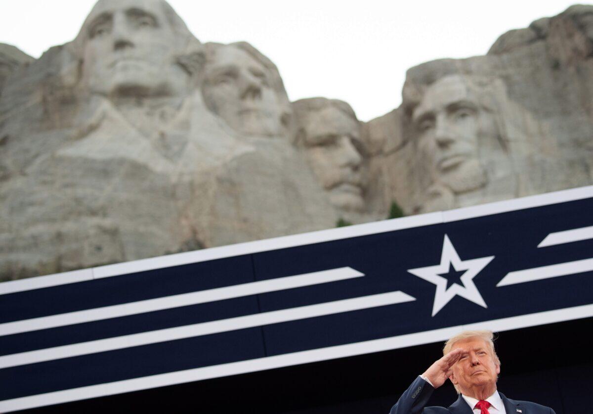 President Donald Trump salutes as he listens to the National Anthem during the Independence Day events at Mount Rushmore National Memorial in Keystone, S.D., July 3, 2020. (Saul Loeb/AFP via Getty Images)