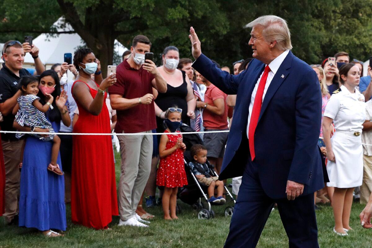 President Donald Trump greets visitors as he walks on the South Lawn of the White House during a "Salute to America" event, in Washington on July 4, 2020. (Patrick Semansky/AP Photo)