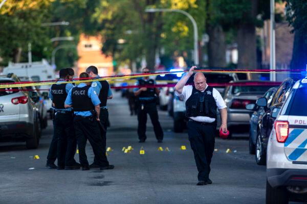 Chicago police officers investigate the scene of a deadly shooting in Chicago on July 5, 2020, where a 7-year-old girl and a man were fatally shot during a Fourth of July party. (Tyler LaRiviere/Chicago Sun-Times via AP)