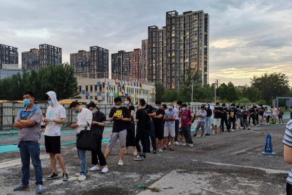 People wait in line to undergo COVID-19 swab tests at a test station in Beijing on July 6, 2020. (Lintao Zhang/Getty Images)