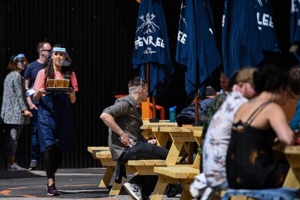 Members of the public enjoy their first drink in a beer garden in Glasgow, Scotland on July 6, 2020. (Jeff J Mitchell/Getty Images)