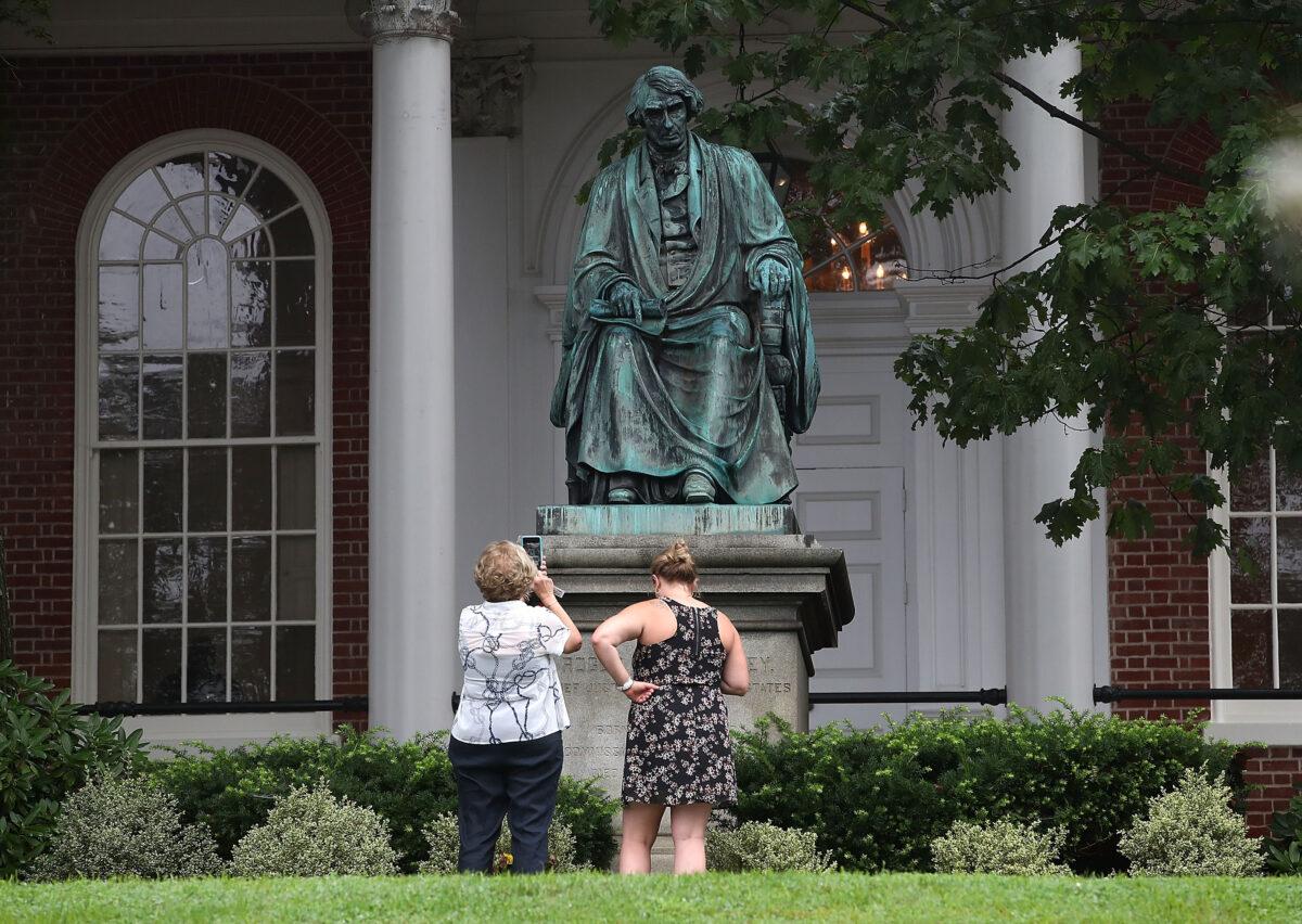 Two women take pictures in front of the statue of US Supreme Court Chief Justice Roger Brooke Taney in a photograph before it was removed, in Annapolis, Md., on Aug. 16, 2017. (Mark Wilson/Getty Images)