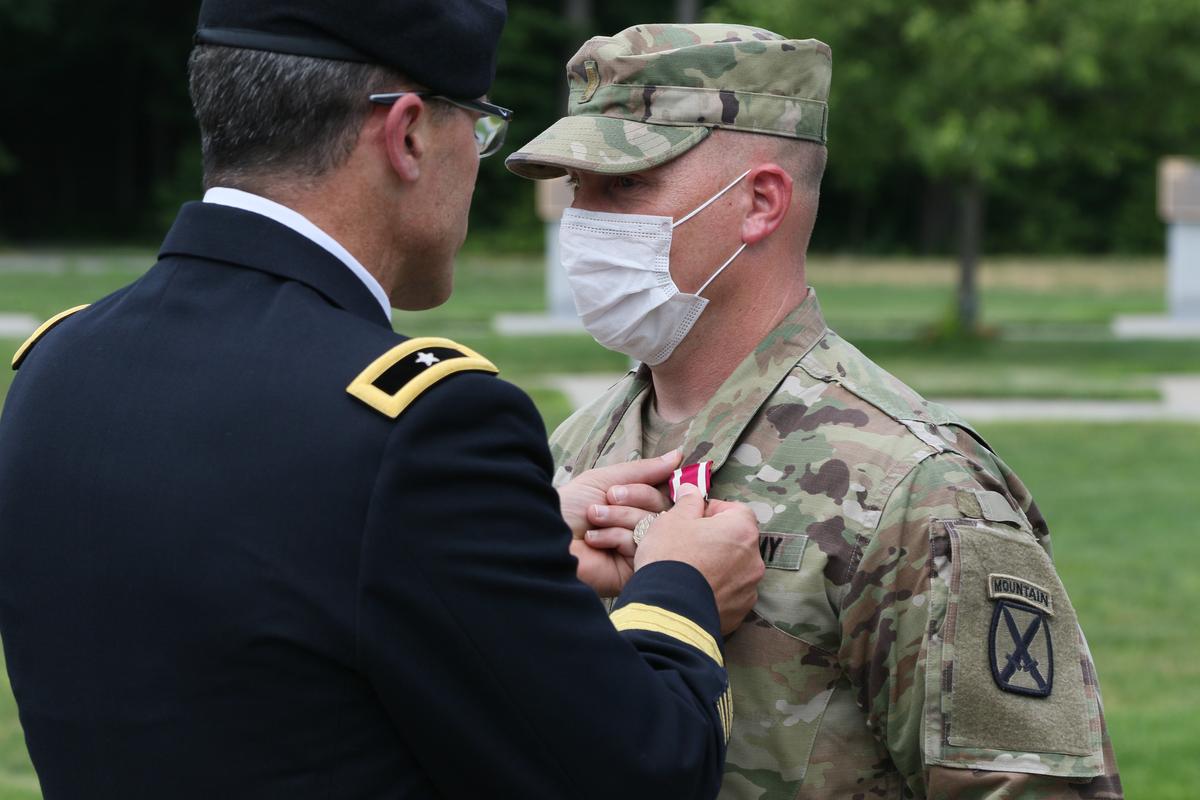 Sutter is presented with the Meritorious Service Medal (MSM) by Brig. Gen. Brett Funck at Memorial Park on Fort Drum, New York. (<a href="https://www.army.mil/article/237008/fort_drum_soldier_performs_heimlich_saves_newborns_life?fbclid=IwAR1F_3G5krVnY31xHDvEenwgMwG7Auoa3pPP3U4JxznkVLLvhRvmiQpn1Hg">Sgt. Brandon Cox</a>/U.S. Army)