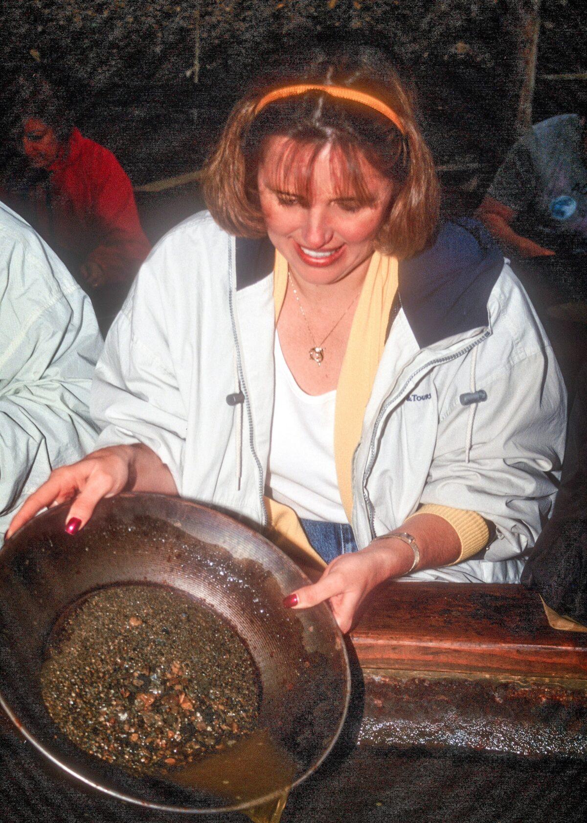 Panning for gold where you are almost certain to actually find some is a popular offering on many Alaska cruise tours. We found $25 worth, and this young woman did a lot better. (Copyright Fred J. Eckert)