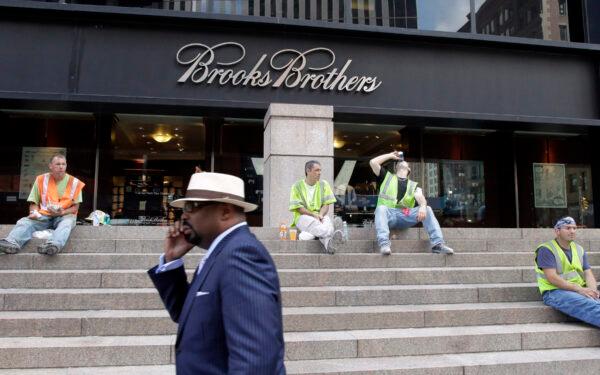 A man walks by a Brooks Brothers store on Church St. in New York, on Sept. 11, 2001. The firm announced it would close down stores earlier in July (Mark Lennihan/File/AP Photo)