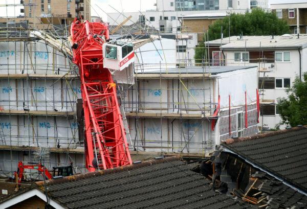 A collapsed crane is seen near a construction site in Bow, east London, Britain, on July 8, 2020. (Hannah McKay/Reuters)