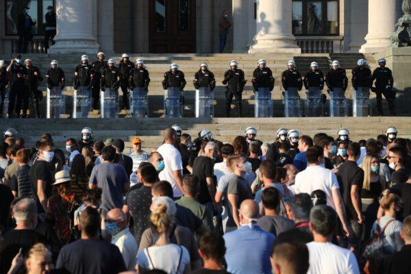 Police officers stand guard as demonstrators gather during an anti-government rally, amid the spread of the disease (COVID-19), in front of the parliament building in Belgrade, Serbia, on July 8, 2020. (Marko Djurica/Reuters)