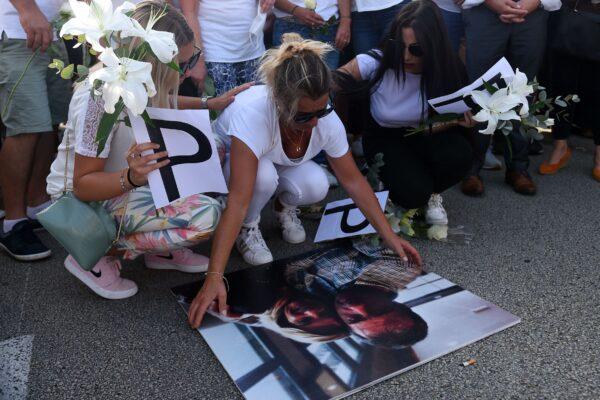 Veronique Monguillot, wife of bus driver Philippe Monguillot, declared brain-dead after being attacked for refusing to let aboard a group of people who were not wearing face masks, holds a picture of her husband during a white march in Bayonne, southwestern France, on July 8, 2020. (Iroz Gaizka/AFP via Getty Images)