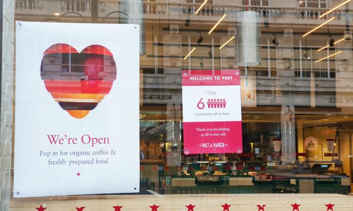 A sign reads "Only 6 customers at a time" is seen on the window of Pret A Manger Restaurant, in London, England, on June 4, 2020. (Lily Zhou/Epoch Times)