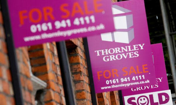 Estate agents boards are seen outside a row of terraced houses in Manchester, England, on July 8, 2020. (Phil Noble/Reuters)