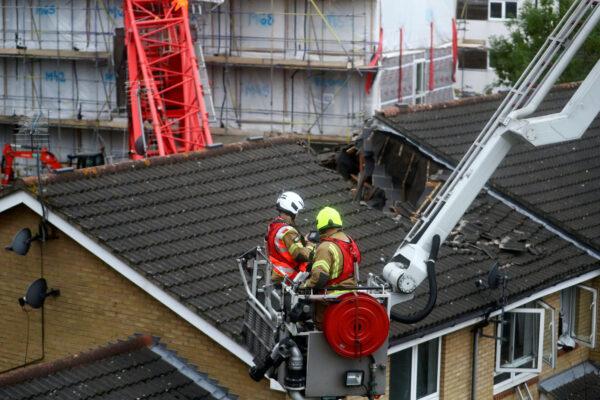 Rescue personnel work at the area where a crane collapsed in Bow, east London, Britain, on July 8, 2020. (Hannah McKay/Reuters)