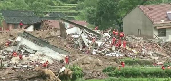 Rescuers dig through the debris in Huanggang City of Hubei Province, after a landslide buried nine people on July 8, 2020. (Screenshot via Reuters)