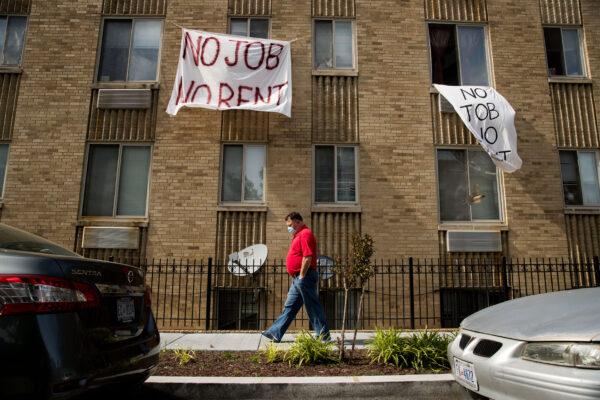 Signs that read 'No Job No Rent' hang from the windows of an apartment building in Washington, on May 20, 2020. (Andrew Harnik/AP Photo)