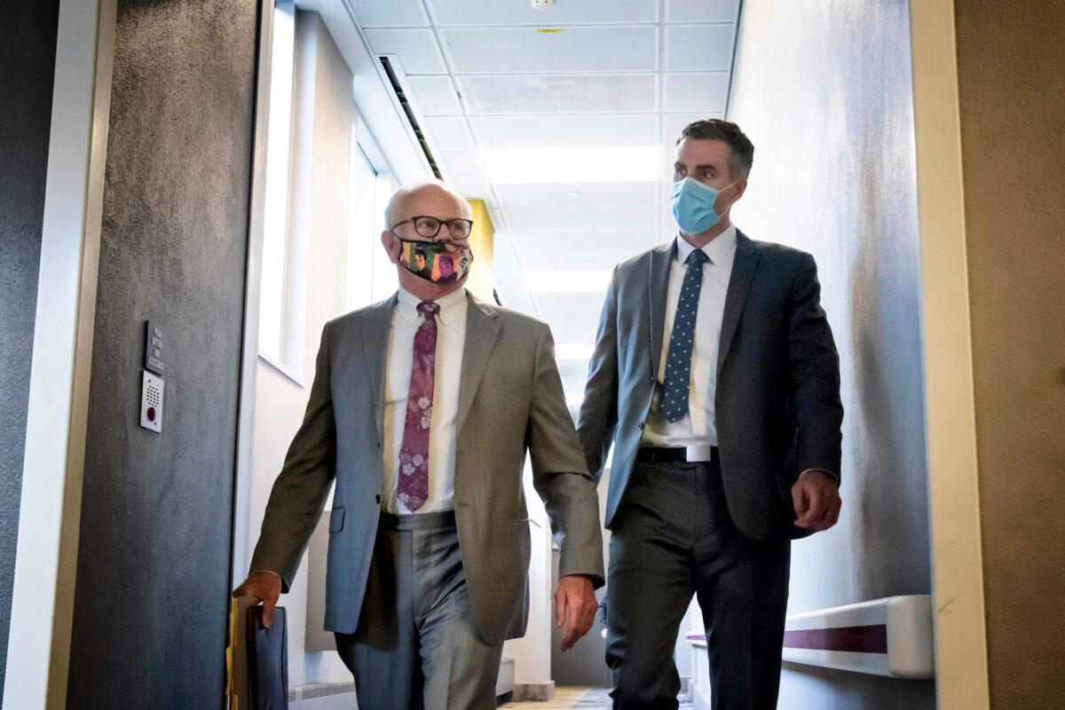 Former Minneapolis police officer Thomas Lane, right, walks out of the Hennepin County Public Safety Facility with his attorney, Earl Gray, after a hearing in Minneapolis on June 20, 2020. (Glen Stubbe/Star Tribune via AP)