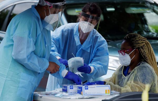 Health workers prepare to give free COVID-19 tests on May 26, 2020, at a drive-through/walk up testing center at Barcroft Community Center in the Arlington, Va., zip code with the highest concentration of Coronavirus cases. (OLIVIER DOULIERY/AFP via Getty Images)