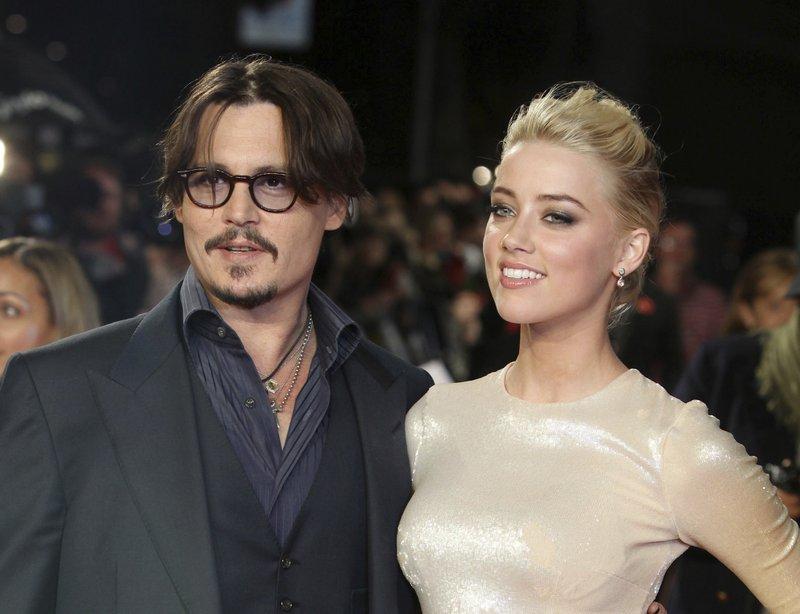 Actors Johnny Depp, left, and Amber Heard arrive for the European premiere of their film, "The Rum Diary," in London, UK, on Nov. 3, 2011. (Joel Ryan/AP Photo)