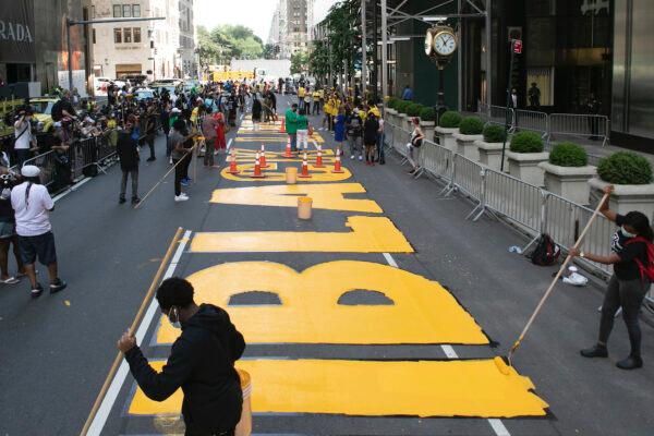 Black Lives Matter is painted on Fifth Avenue in front of Trump Tower, in New York, July 9, 2020. (AP Photo/Mark Lennihan)
