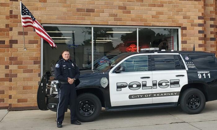 Nebraska Cop Caught on Camera Fixing Fallen American Flag Outside Auto Repair Shop