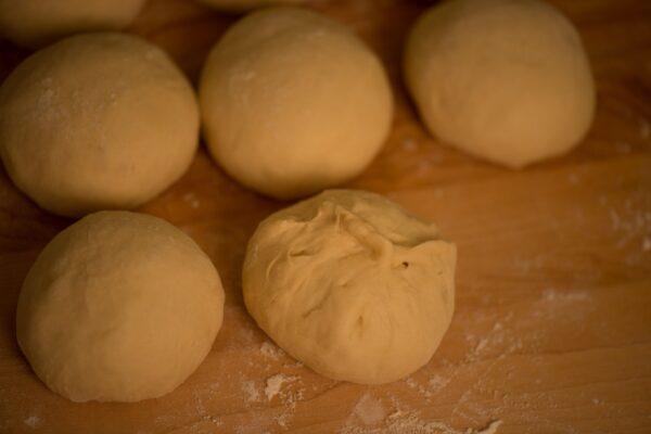 Pull and pinch each piece of dough into a ball. (Photo by Susan Butler)