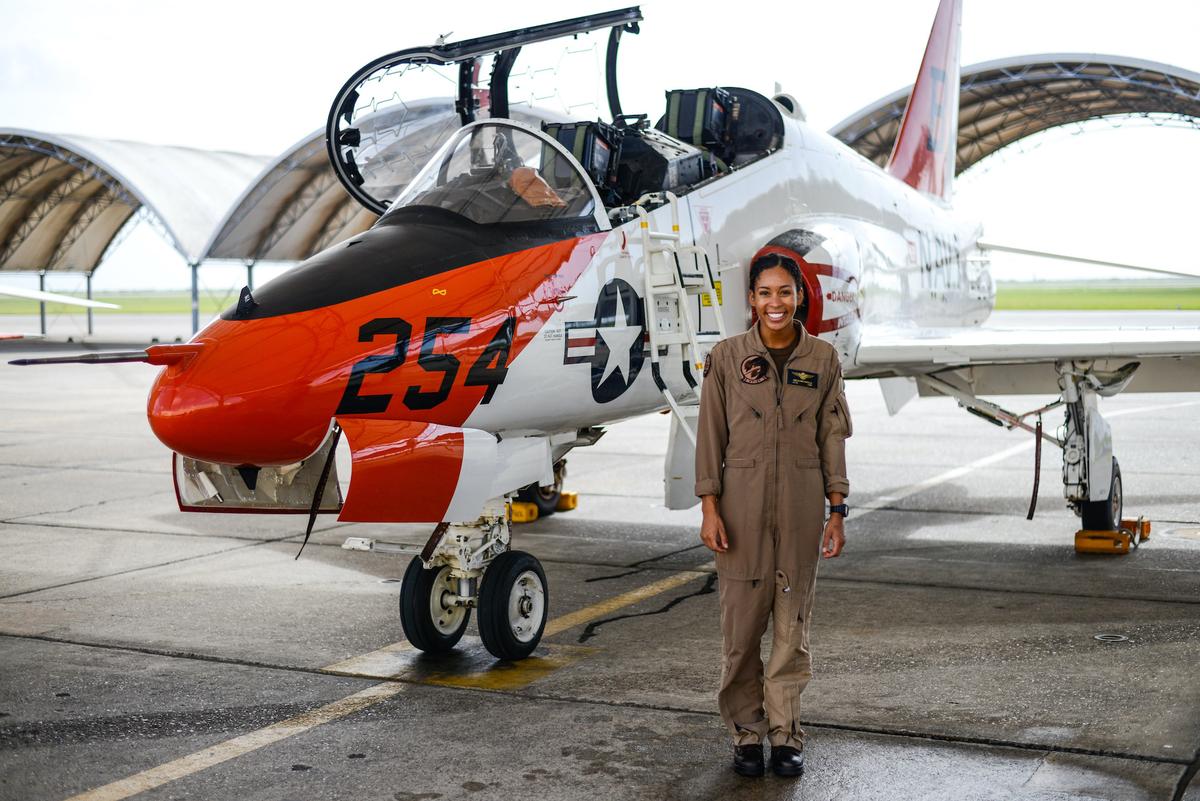 Student Naval Aviator Lt. j.g. Madeline Swegle, assigned to the Redhawks of Training Squadron (VT) 21 at Naval Air Station Kingsville, Texas, stands by a T-45C Goshawk training aircraft. (<a href="https://www.navy.mil/view_image.asp?id=317471">Lt.j.g. Luke Redito</a>/U.S. Navy)