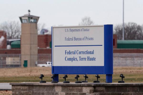 A guard tower flanks the sign at the entrance to the U.S. Penitentiary in Terre Haute, Ind., on Dec. 10, 2019. (Michael Conroy/AP Photo)