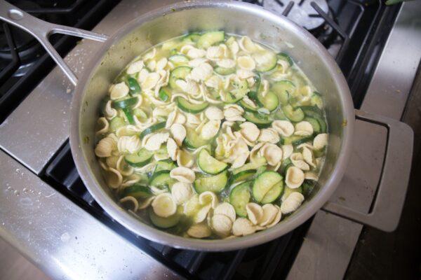 By cooking the pasta and zucchini together in the same pot, we can use the starchy cooking liquid to build our creamy, zucchini-based sauce. (Caroline Chambers)