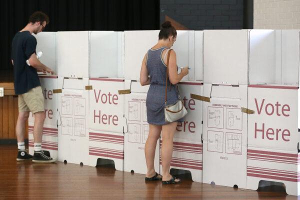 Australian voters are filling in ballot papers at Brisbane City Hall in Brisbane, Australia, on March 28, 2020. (Jono Searle/Getty Images)