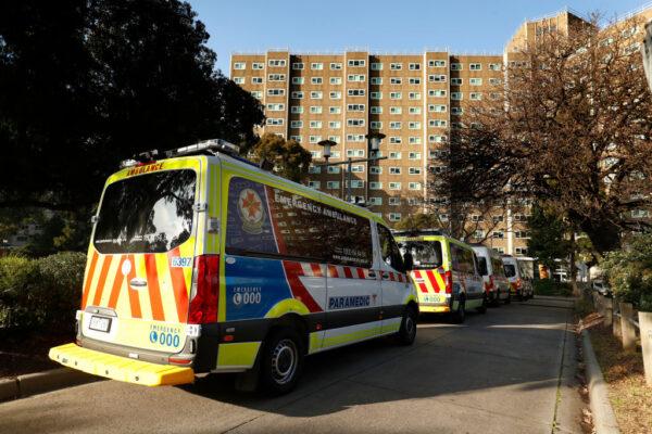A row of Ambulances are seen lined up outside the North Melbourne Public Housing tower complex in Melbourne, Australia on July 8, 2020. (Darrian Traynor/Getty Images)