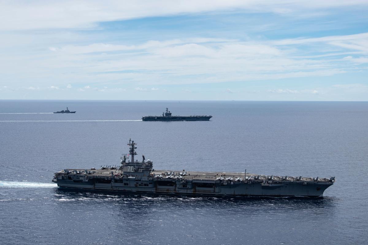 The USS Ronald Reagan (CVN 76, front) and USS Nimitz (CVN 68, rear) Carrier Strike Groups sail together in formation, in the South China Sea, on July 6, 2020. (Mass Communication Specialist 3rd Class Jason Tarleton/U.S. Navy via AP)