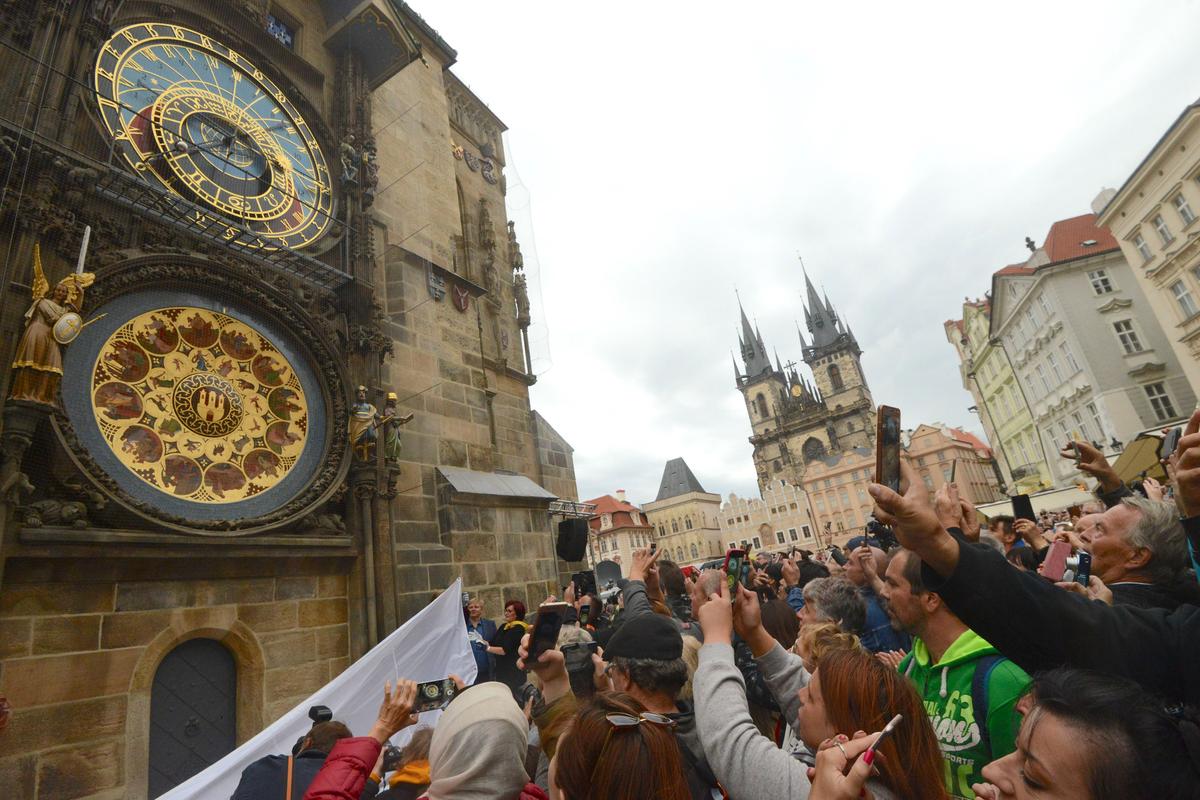 People attend the unveiling of Prague's restored astronomical clock on the Old Town Square on Sept. 28, 2018. (MICHAL CIZEK/AFP via Getty Images)
