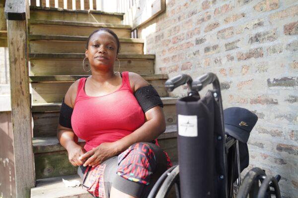 Tywone Lee sits on the stairs of her apartment in Austin, Chicago, on July 1, 2020. Her 18-year-old son was killed by gunfire a few blocks away in 2016. (Cara Ding/The Epoch Times)