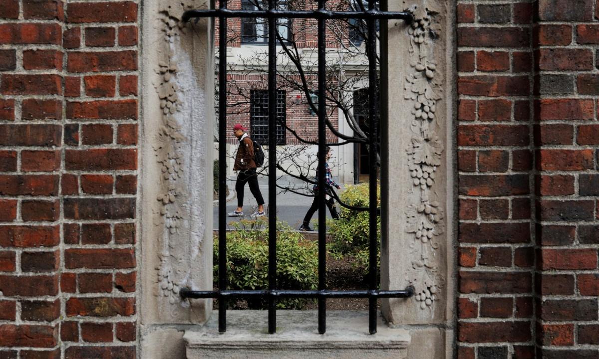  Students and pedestrians walk through the Yard at Harvard University, in Cambridge, Mass., on March 10, 2020. (Brian Snyder/Reuters)