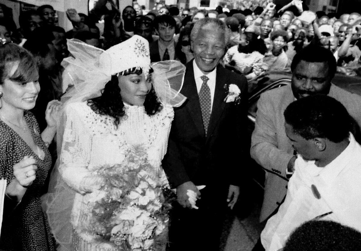 The late Nelson Mandela (C) holds the hand of his daughter, Zindzi, at her marriage in Johannesburg, South Africa, on Oct. 1992. (Matt Dunham/File/AP Photo)