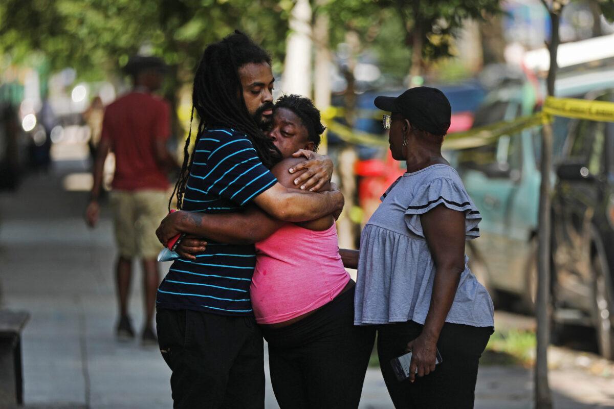 Relatives of the dead and wounded grieve near the scene in Brooklyn where a 1-year-old child was shot and killed in New York City on July 13, 2020. (Spencer Platt/Getty Images)