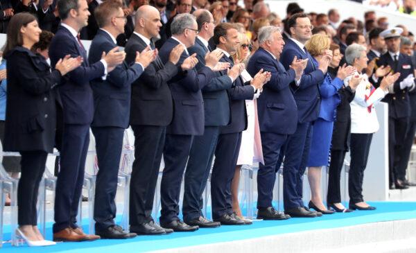 <br/>Paris mayor Anne Hidlago, French Health Minister Olivier Veran, Austrian Health minister Rudolf Anschober, Swiss Health minister Alain Berset, President of the French Assembly Richard Ferrand, French Prime Minister Jean Castex, French President Emmanuel Macron and his wife Brigitte Macron, President of the French Senate Gerard Larcher, German Health Minister Jens Spahn, Luxembourg Health minister Paulette Lenert, French Defence Minister Florence Parly and French Junior Minister of Remembrance and Veterans Affairs Genevieve Darrieussecq applaud at the end of the annual Bastille Day military ceremony on the Place de la Concorde in Paris, on July 14, 2020. (Ludovic Marin/Reuters)