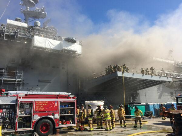 Sailors and Federal Fire San Diego firefighters combat a fire aboard USS Bonhomme Richard (LHD 6) July 12, 2020. (U.S. Navy photo by Mass Communication Specialist 1st Class Jason Kofonow/Released)