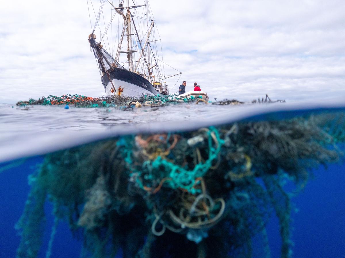 An abandoned fishing net pictured in front of the Ocean Voyages Institute's ship (Courtesy of <a href="https://www.oceanvoyagesinstitute.org/ocean-voyages-institute-sets-record-with-largest-open-ocean-clean-up-in-history/">Ocean Voyages Institute</a>)