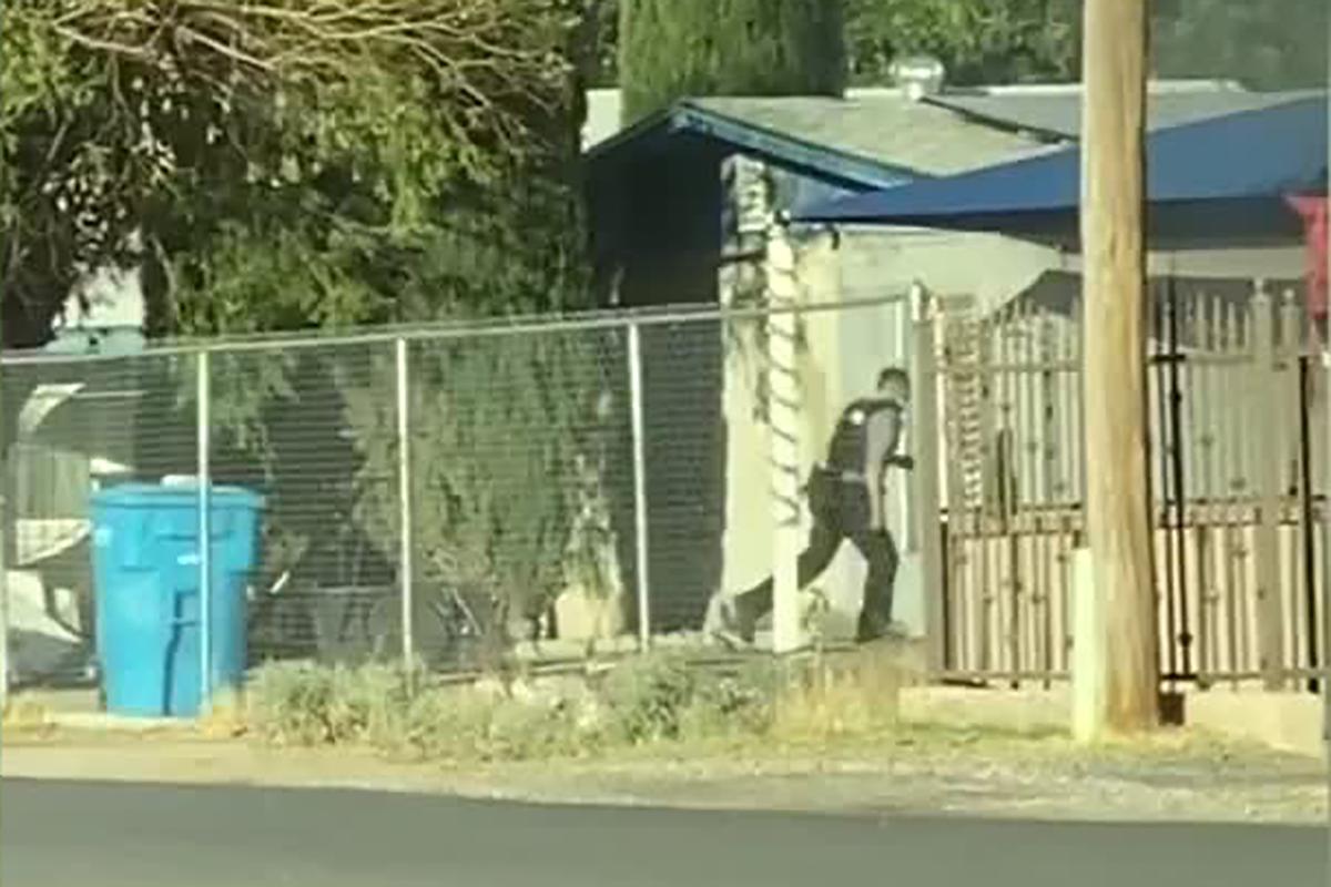 Police officer Joshua Gonzalez running toward a burning mobile home in Socorro. (Courtesy of Cristobal Marin)