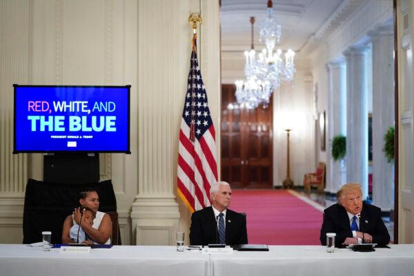 (L-R) Jakebia Northcutt and her son David Northcutt, who was saved by police during an attempted kidnapping in Palm Beach County, Florida, Vice President Mike Pence and President Donald Trump attend an event about citizens positively impacted by law enforcement, in the East Room of the White House in Washington, on July 13, 2020. (Drew Angerer/Getty Images)