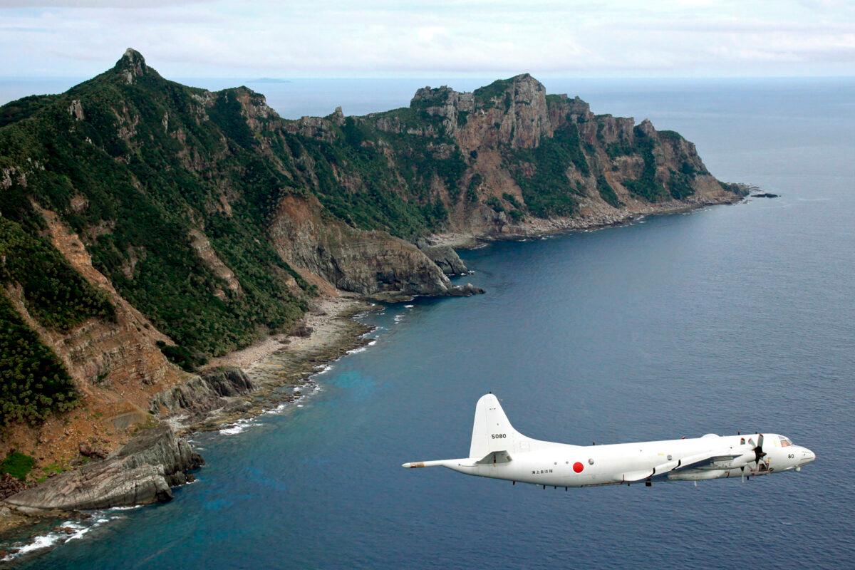 A Japan Maritime Self-Defense Force P-3C Orion surveillance plane flies over the disputed islands, called the Senkaku in Japan and Diaoyu in China, in the East China Sea on Oct. 13, 2011. (Kyodo News via AP/File)