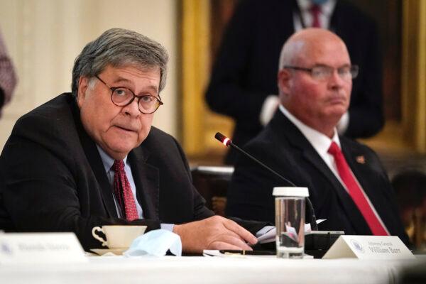 Attorney General William Barr (L) attends an event about citizens positively impacted by law enforcement, in the East Room of the White House in Washington, July 13, 2020. (Drew Angerer/Getty Images)